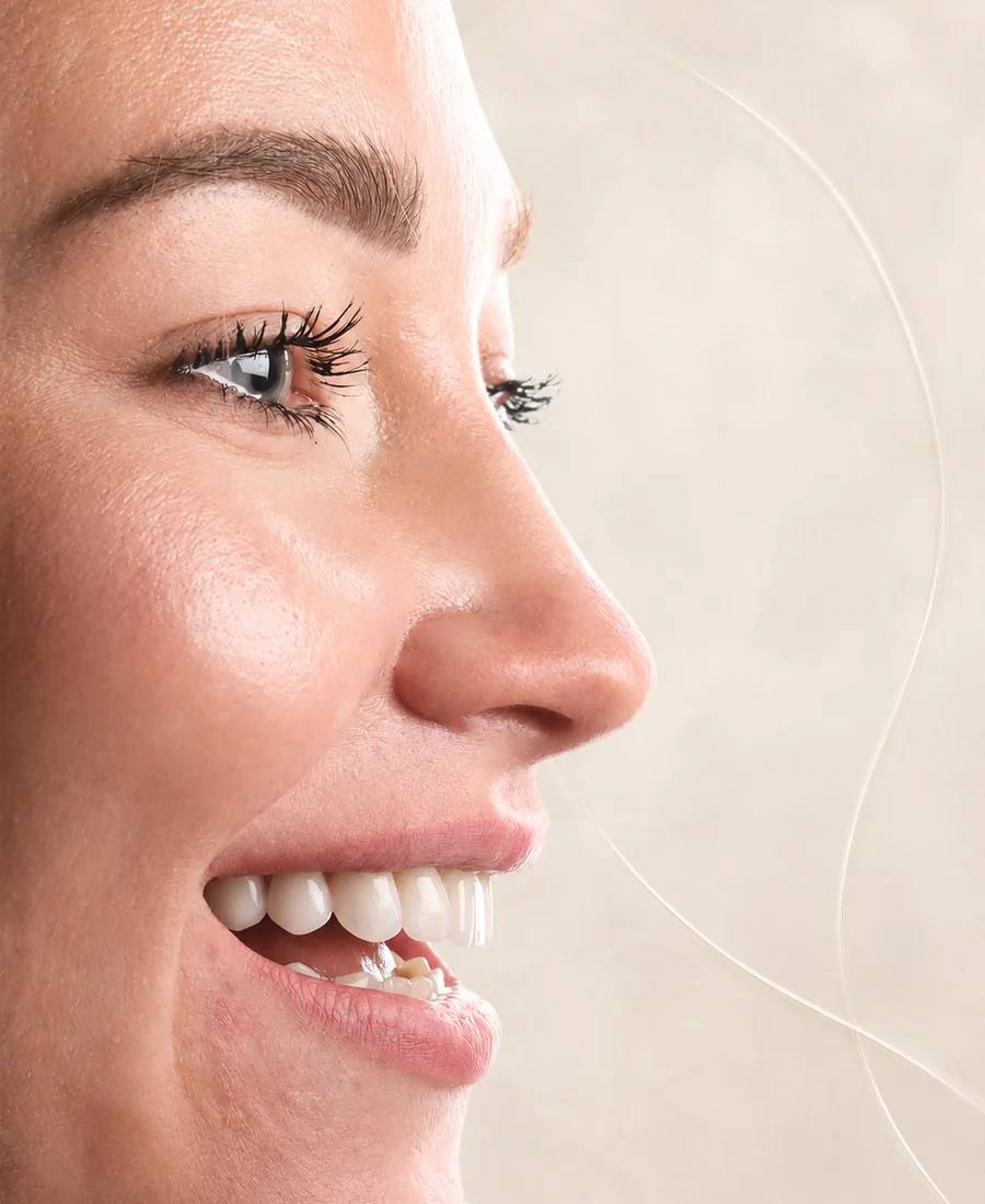 A patient smiling after treatment at Imperia Dent